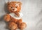 Concept teddy bear childhood diseases at textile background