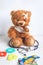 Concept teddy bear childhood diseases at textile background