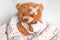 Concept teddy bear childhood diseases at textile background