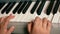 Concept on the theme of a child playing a musical instrument. Close-up of children`s hands playing the keys of a piano, learning t