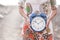 Concept of time and timeless lifestyle - unrecognizavble woman hold a clock on his hands - defocused background