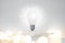 Concept on the topic of ideas and education. A realistic light bulb with garlands and a set of doodle icon isolated on
