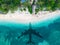 The concept of travel and air travel. Top view of the sandy coast of the ocean, with the shadow on the water from the landing