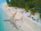 The concept of travel and air travel. Top view of the sandy ocean coast with people, with the shadow on the water from the plane