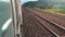 Concept travel train wagon journey. View through the train window of the wagons in the composition passing nature