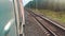 Concept travel train wagon journey. View through the train window of the wagons in the composition passing nature