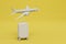 the concept of traveling by plane. plane and suitcase with luggage on a yellow background. copy paste. 3D render