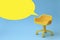 Concept of vacant chair. Yellow stool on blue clean background. Photo in minimal style