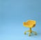 Concept of vacant chair. Yellow stool on blue clean background. Photo in minimal style