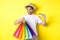 Concept of vacation and finance. Happy man shopper looking at shopping bags satisfied, showing credit card, standing