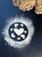 Concept Of Valentine`s Day. Picture of heart of flour on a black background. Happy Valentines Day background