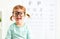 Concept vision testing. child girl with eyeglasses