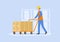 Concept Of Warehouse. Storehouse Cheerful Worker In Uniform Pushing Cart With Parcels. Modern Warehouse With Cardboard