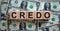 Concept word `credo` on cubes on a beautiful background from dollar bills. Business concept