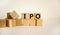 Concept word `IPO` - `initial public offering` on wooden cubes on a beautiful white background. Business concept. Copy space