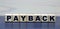 Concept word PAYBACK on wooden cubes on a beautiful background