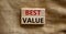 Concept words `best value` on wooden blocks on a beautiful canvas background. Business concept