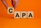 Concept words `CAPA, corrective and preventive actions` on wooden cubes on a beautiful orange background. Male hand. Business