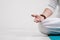 Concept of yoga and meditation. Close-up, hands of a man in white clothes, folded in prayer. White background and yellow