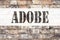 Conceptual announcement text caption inspiration showing ADOBE. Business concept for Software Company Name written on old brick ba