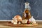 Conceptual composition of different spices and oil bottle on a wooden tray on rustic table, close-up, selective focus