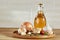 Conceptual composition of different spices and oil bottle on a wooden tray on rustic table, closeup, selective focus.