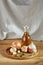 Conceptual composition of different spices and oil bottle on a wooden tray on rustic table, closeup, selective focus.