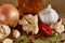 Conceptual composition of different spices and oil bottle on a wooden tray on rustic table, closeup, selective focus.