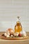 Conceptual composition of different spices and oil bottle on a wooden tray on rustic table, closeup, selective focus.