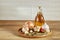 Conceptual composition of different spices and oil bottle on a wooden tray on rustic table, closeup, selective focus.