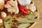 Conceptual composition of different spices on a wooden tray on rustic table, close-up, selective focus