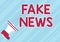 Conceptual display Fake News. Word Written on false information publish under the guise of being authentic news