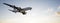 Conceptual flying white passenger jetliner or commercial plane after take off rising over a beautiful sky background