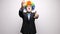 Conceptual footage of clown in business suit making shot signs from hands