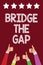 Conceptual hand writing showing Bridge The Gap. Business photo text Overcome the obstacles Challenge Courage Empowerment Men women