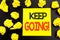 Conceptual hand writing text showing Keep Going. Business concept for Go Moving Forward Letting written on sticky note paper. Fold