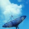 Conceptual image of a satellite dish antenna over night sky with