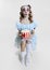 Conceptual image of young girl wearing Halloween dress of dancing clown with spooky make-up isolated on grey background.