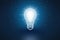 Conceptual light bulb on blue background