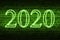 A conceptual message written by the green neon light on the wall shows `2020`. Business motivation, inspiration concepts ideas.