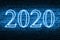 A conceptual message written by the neon light on the wall shows `vision 2020`. Business motivation, inspiration concepts ideas.