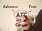 Conceptual photo about AYC Advance Your Career . Hand holding a marker pen to write on officce background