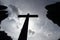 conceptual photo of death - silhouette of a large cross with the background sky and the typical hedges