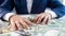 Conceptual photo of greed and avarice. Businessman grabbing money lying on office desk