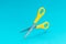 Conceptual photo of opened levitating yellow scissors with central composition