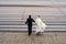 Conceptual symbolic photography. At the crosswalk, the bride in white, the groom in black. Metaphor of the beginning, the