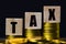 Conceptual about tax benefit or mandatory financial charge. Wooden block on stacked coins with text. Depicts Taxes are related to
