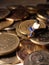 Conceptual Top View, Close Up Photo, Sitting Man Beyond Singapore Dollar Rupiah Indonesia Golden Coin, controlling his business