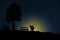 Conceptual valentine holiday illustration. A happy couple silhouette standing at the hill enjoying moon light