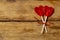 Conceptual Valentines image of Two cute red heart shaped lollipops on rustic wooden